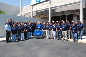 custom manufacturing & engineering company photo with all employees and power supply